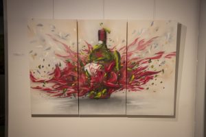 Wine bottle and a woman graffiti on a canvas