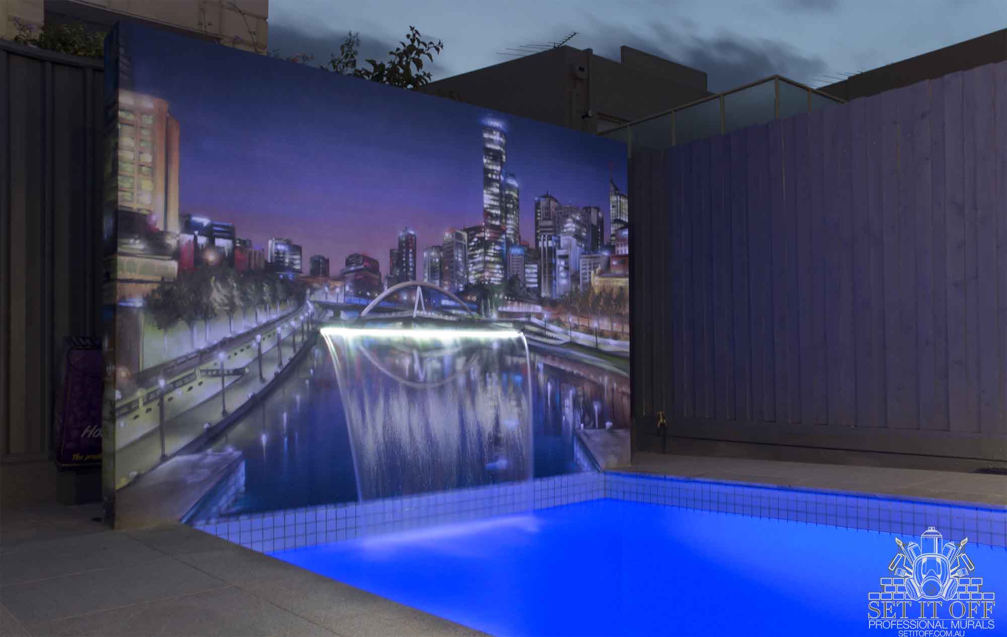 Poolside cityscape wall mural with incorporated fountain