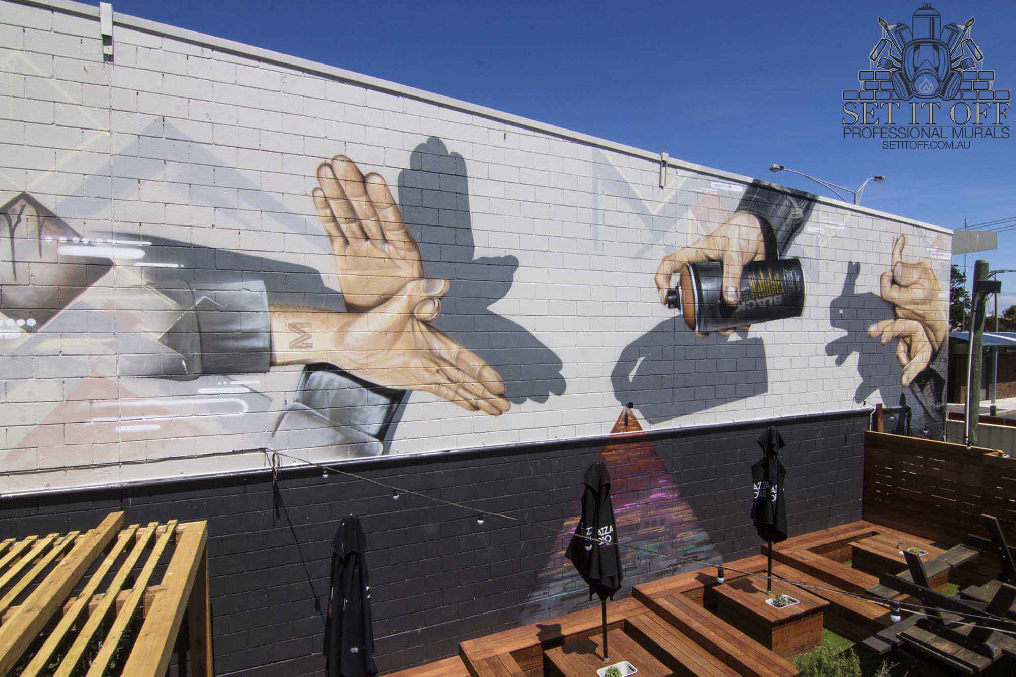Shadow puppets large-scale photorealistic wall mural for outdoor entertainment area.