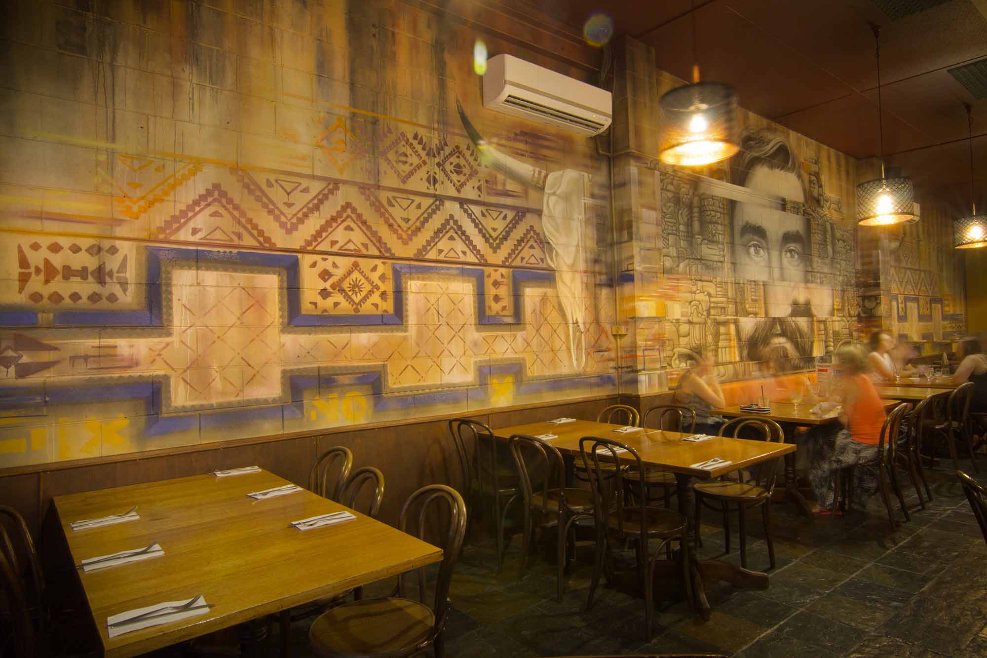 Pyramid graffiti spark up the interior of a Mexican restaurant.