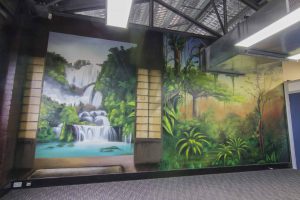 Three-wall urban rainforest spray paint wall mural interior.