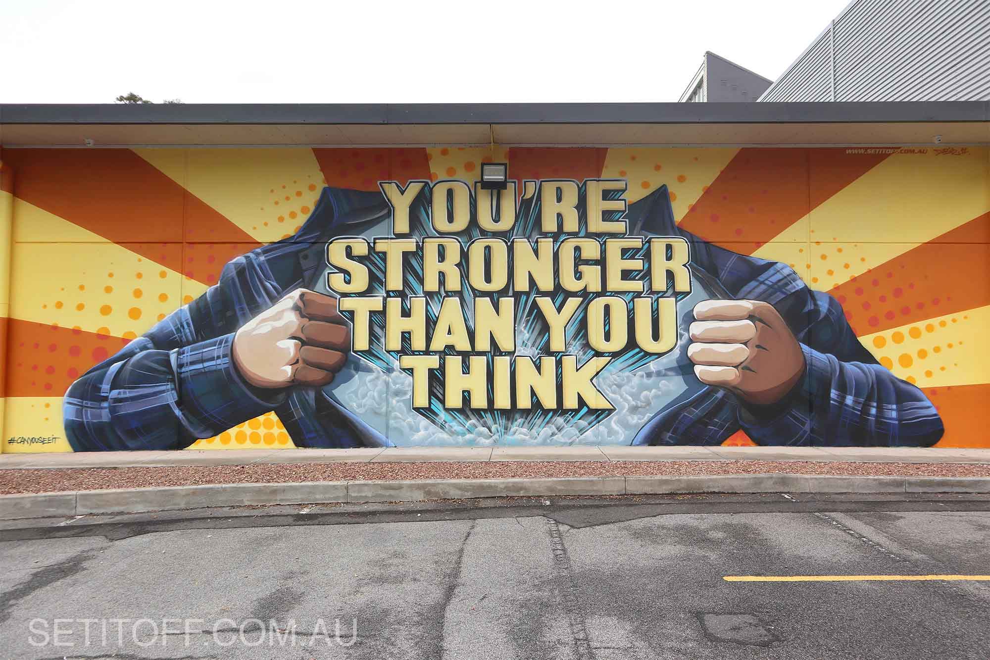 Motivational quote on a graffiti mural