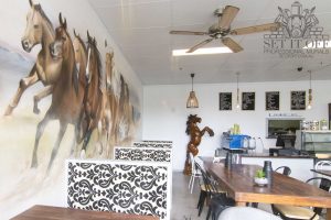 Horses graffiti mural in a cafe