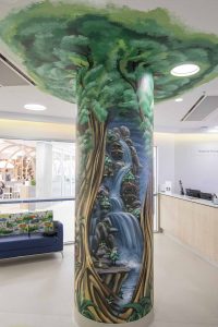 Enchanted tree mural on a pillar