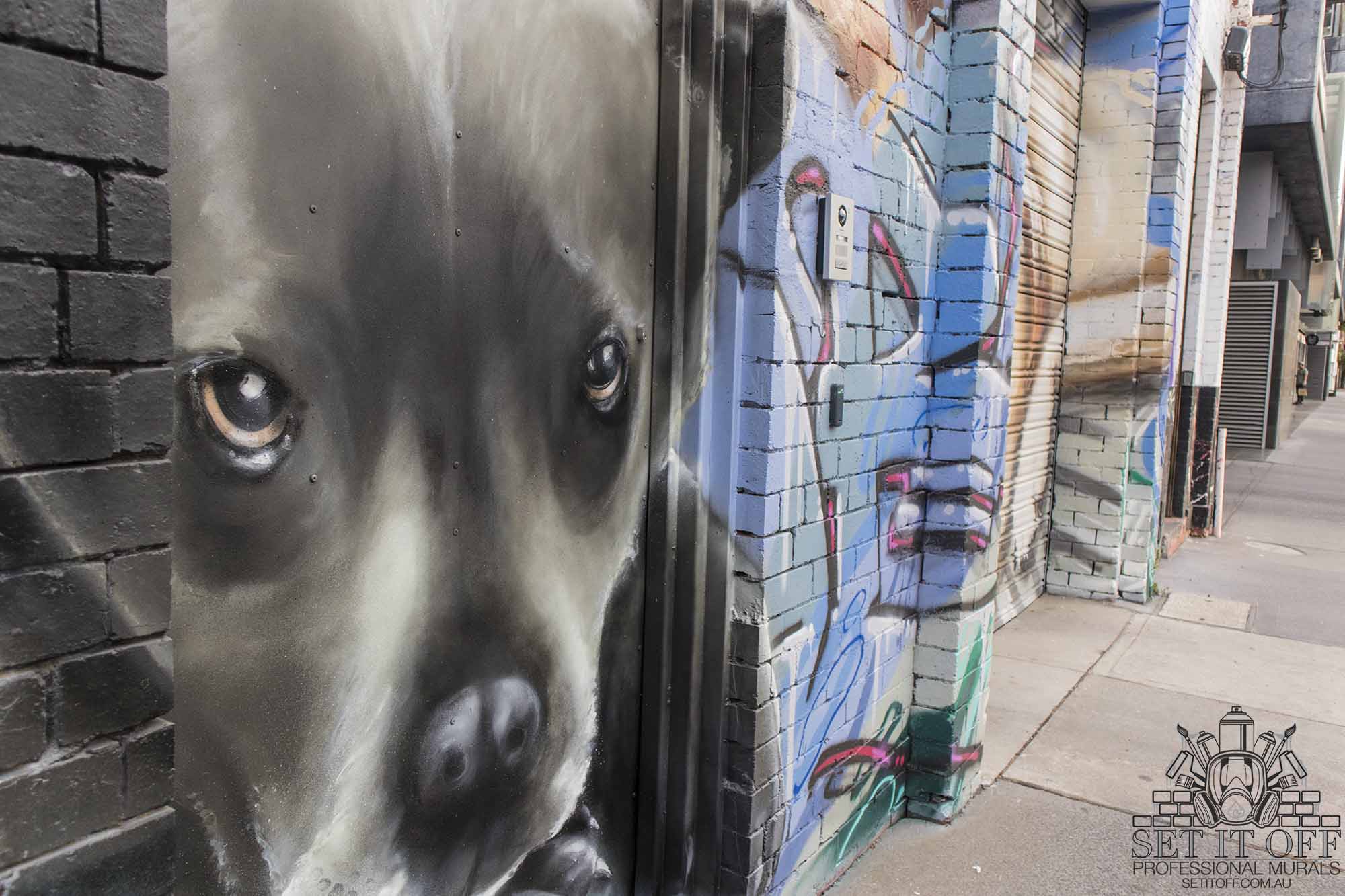 Portraits of dogs on garage door.